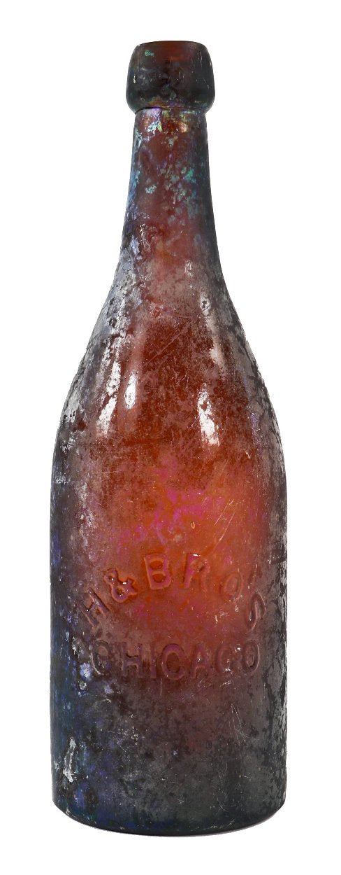 exceptionally rare c. early 1870's heavily irridized amber champagne style bottle manufactured for the hausburg brothers in chicago, il.