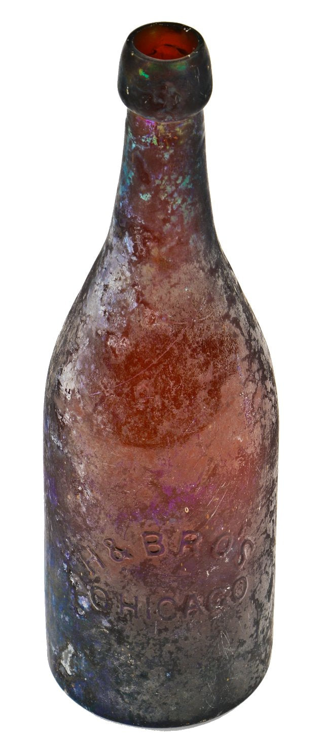 exceptionally rare c. early 1870's heavily irridized amber champagne style bottle manufactured for the hausburg brothers in chicago, il.