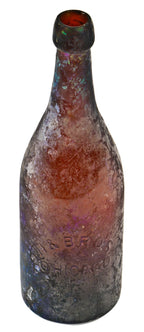 exceptionally rare c. early 1870's heavily irridized amber champagne style bottle manufactured for the hausburg brothers in chicago, il.