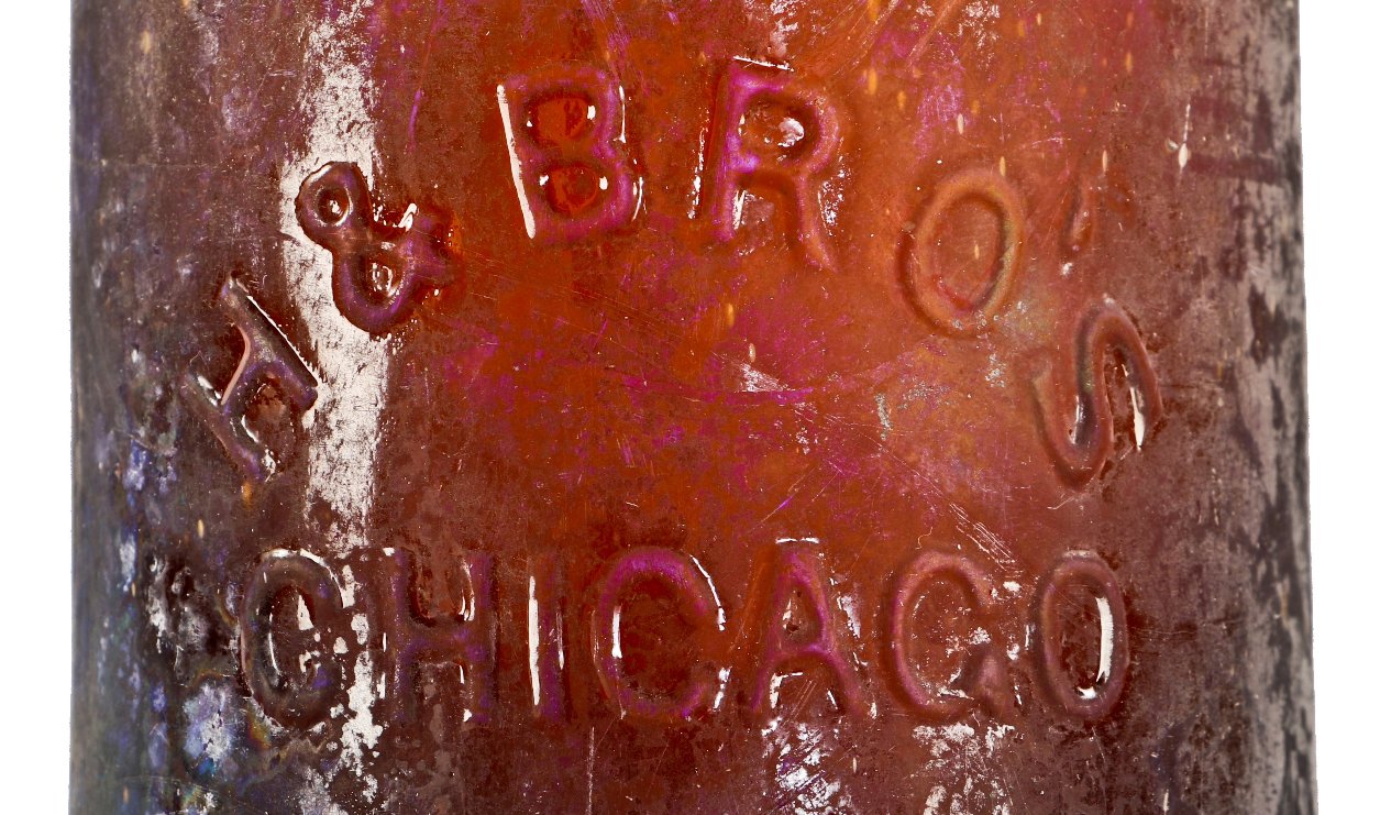 exceptionally rare c. early 1870's heavily irridized amber champagne style bottle manufactured for the hausburg brothers in chicago, il.