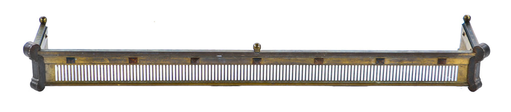 single oversized late 19th or early 20th century brass and iron interior residential ornamented fireplace hearth surround or fender with opposed volutes