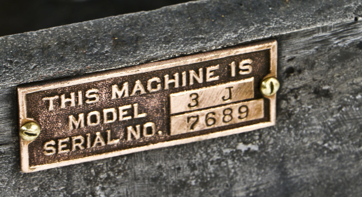 refinished c. 1910 antique american industrial brushed cast iron low-lying four-legged automatic feed press machine base with original bronze model identification plaque