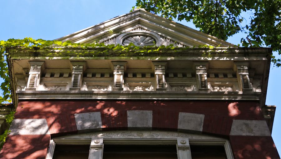 oversied 1880s american victorian era galvanized sheet iron exterior residential circular-shaped "sunburst" roofline cornice rondel with crazed white paint