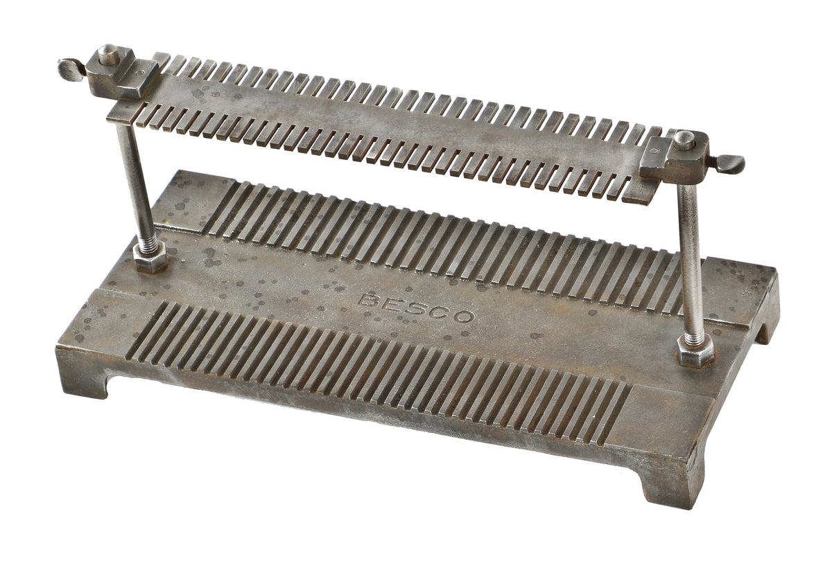 intact and refinished desk or countertop early twentieth century american industrial heavy duty cast iron and steel adjustable slotted "besco" rack or shelving unit