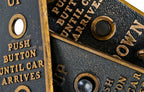 one of three matching original c. 1920's american antique industrial brass-plated cast bronze flush mount elevator cab or car push button "call" plaque with baked black enameled inlay