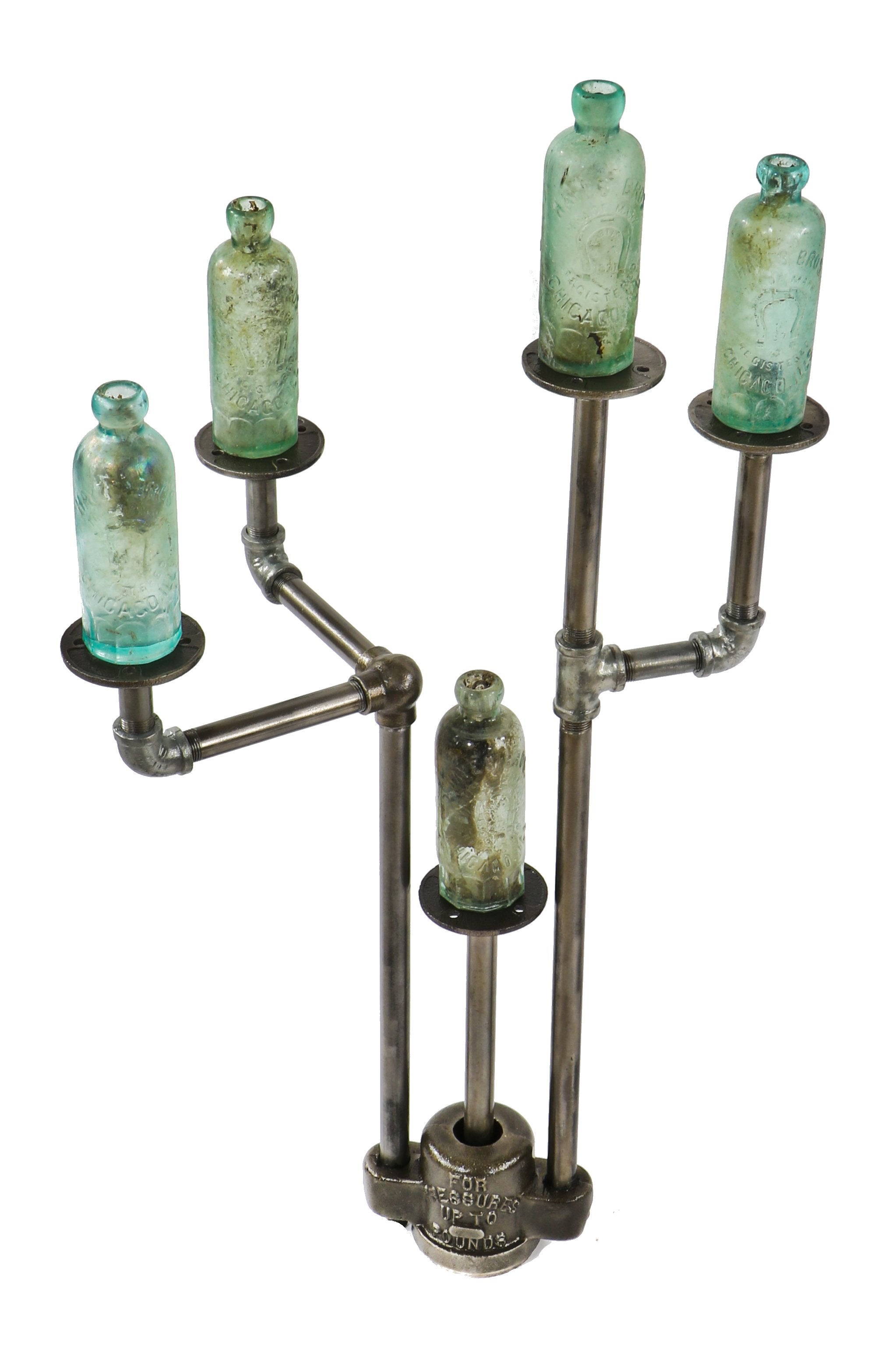 repurposed vintage american industrial object display stand with weighted boylston cast iron grease trap valve cover and old crane plumbing pipe fittings