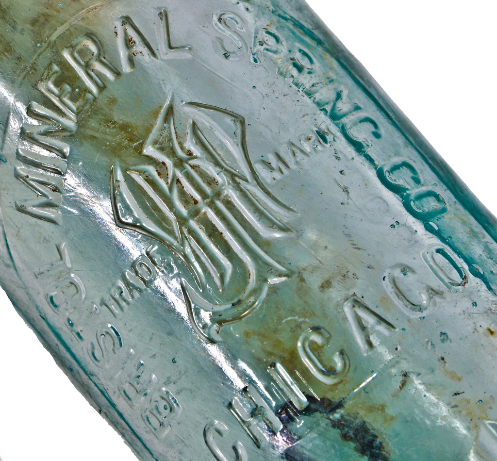 original and intact turn of the century dug deep blue aqua hutchinson bottle with mug base manufactured for the bristol mineral spring company.
