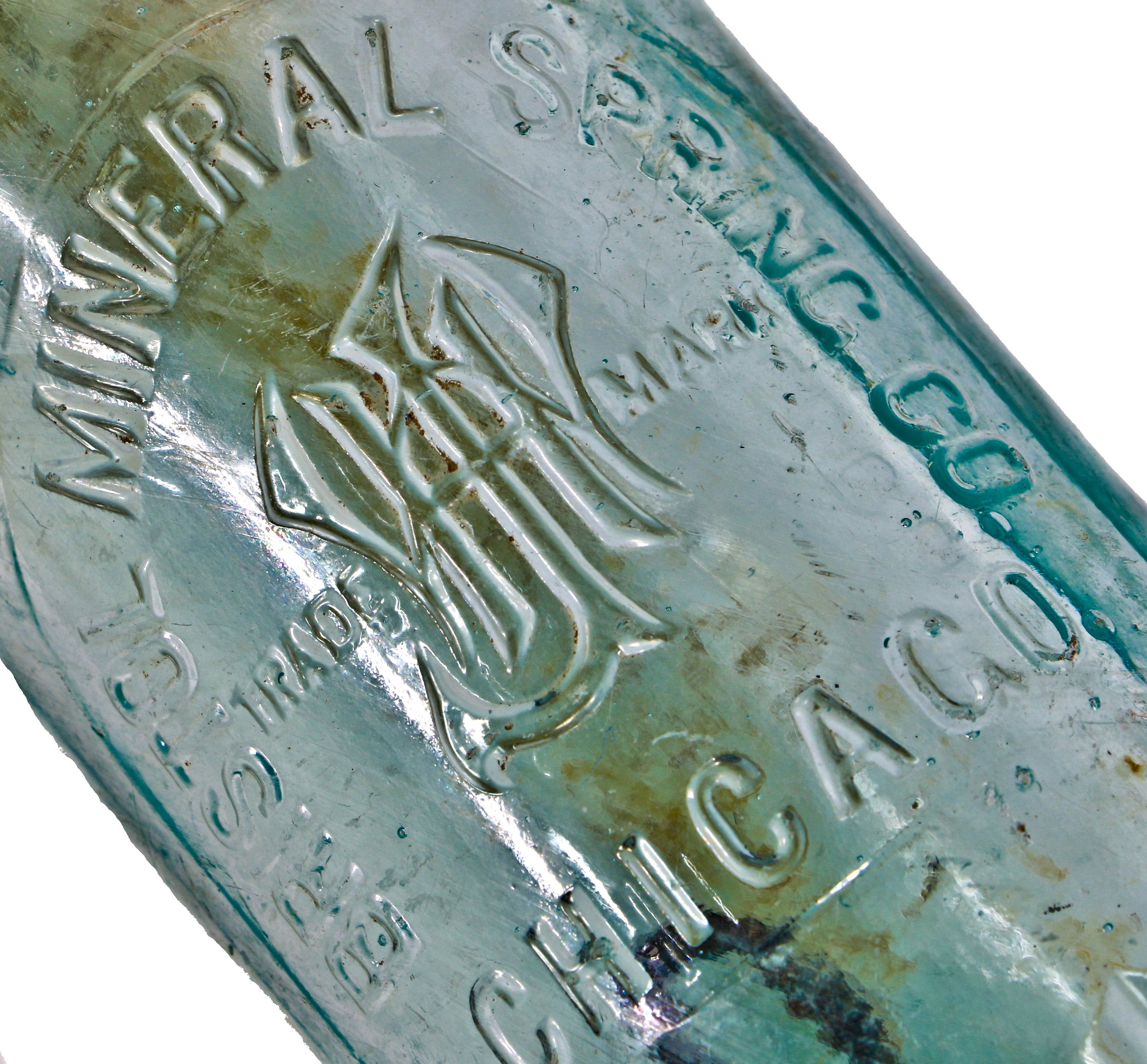 original and intact turn of the century dug deep blue aqua hutchinson bottle with mug base manufactured for the bristol mineral spring company.