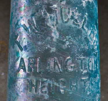 original late nineteenth century dug heavily irridized aqua blue hutchinson style blobtop soda bottle manufactured for arlington heights bottler frederick w. muller.