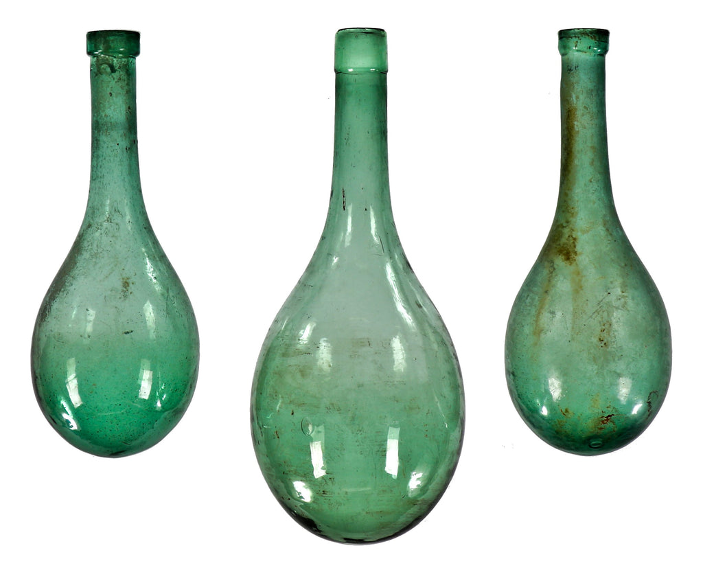 lot of three nearly identical mid-nineteenth century hand blown chianti rounded wine flasks salvaged from the former howard johnson inn.