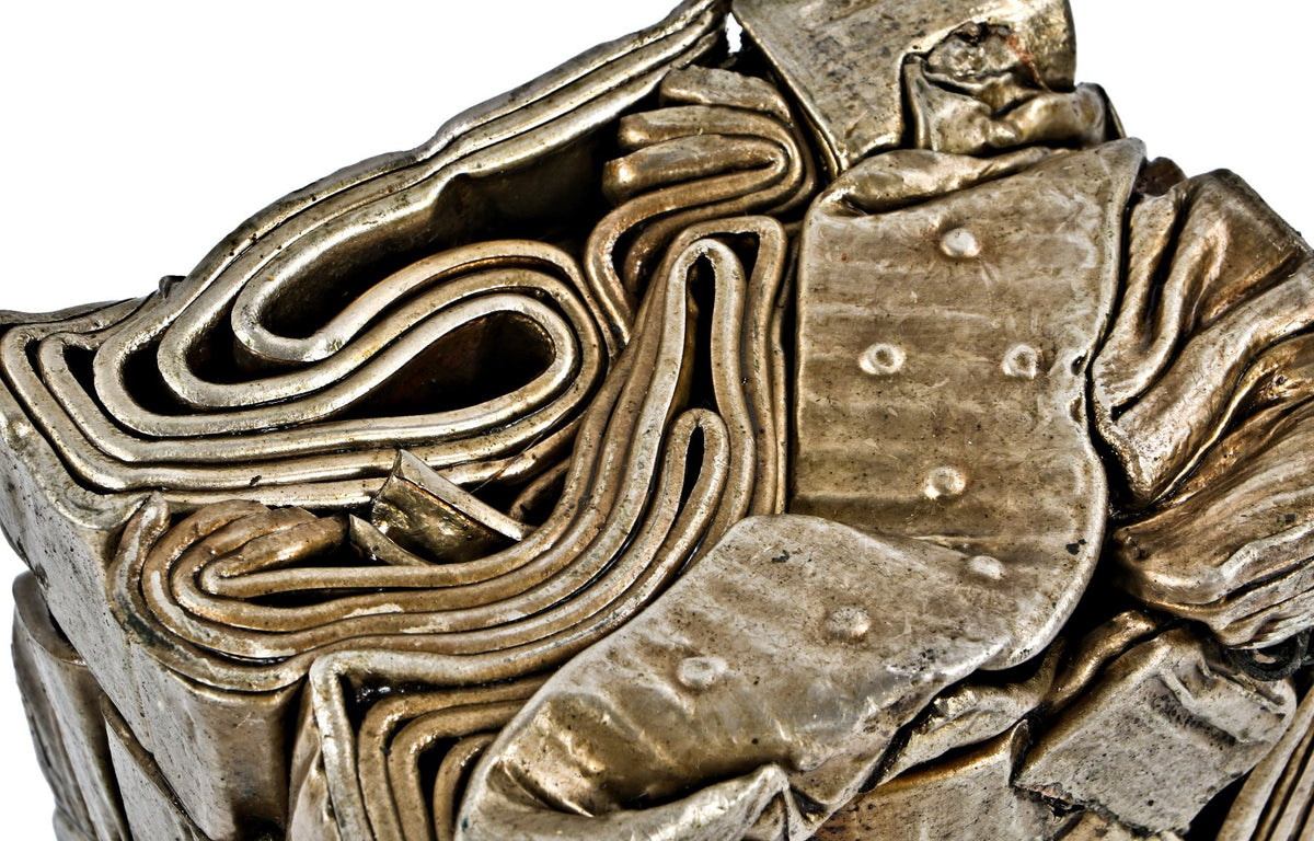 visually distinctive and incredibly heavy single crushed brass metal "briquette" display object consisting of recycled radiator components and/or piping
