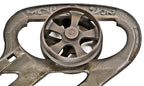 single early 1880's original and fully functional interior residential antique american victorian era ornamental cast iron pocket or sliding door hanger with spoked track wheel