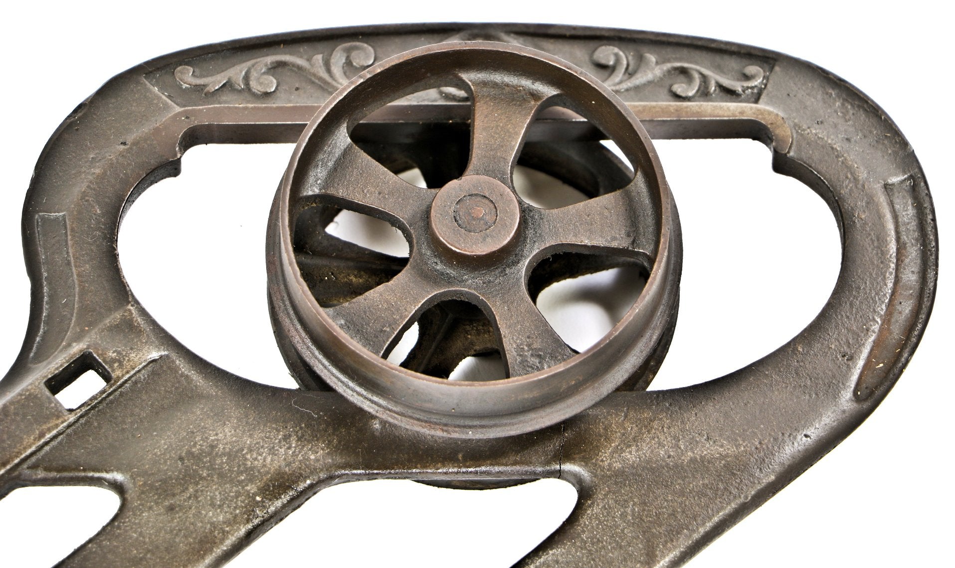 single early 1880's original and fully functional interior residential antique american victorian era ornamental cast iron pocket or sliding door hanger with spoked track wheel
