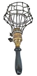 all original and completely intact early 20th century black enameled turned wood handle portable lamp with patented mcgill spring cushion guard or cage
