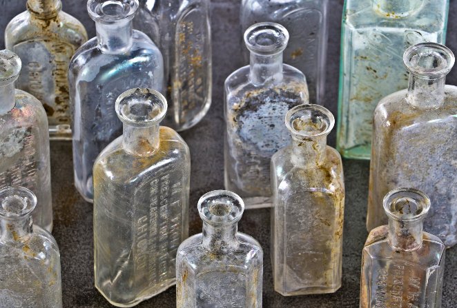 assortment of original late 19th and early 20th century privy-dug chicago druggist bottles with bold and deeply embossed markings
