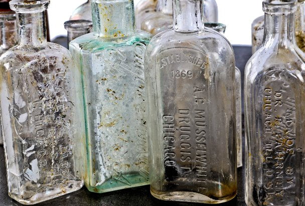 assortment of original late 19th and early 20th century privy-dug chicago druggist bottles with bold and deeply embossed markings