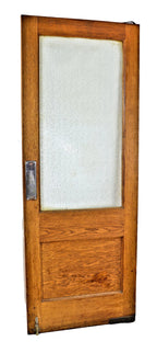one of two matching original original early 20th century varnished golden oak wood residential pantry swinging door with intact large "florentine" pattern privacy glass pane