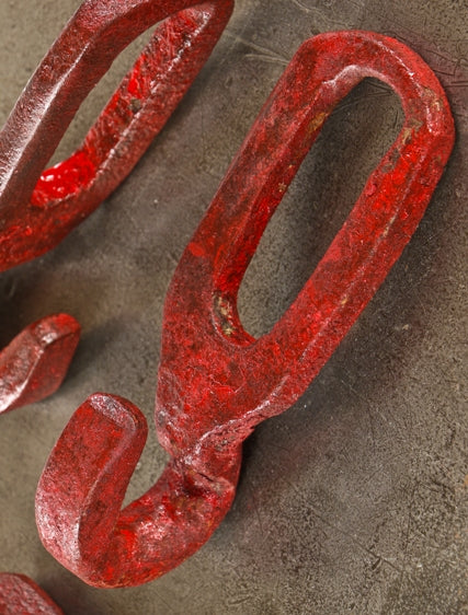 group of four nicely distressed oversized late 19th or early 20th century hand-forged wrought iron red painted interlocking hooks from a factory or farmstead