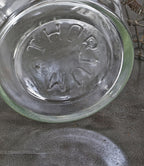 all original and seldom found oversized early 20th century antique american industrial well-maintained and cleaned clear glass "thorium" laboratory bottle with original ground glass stopper