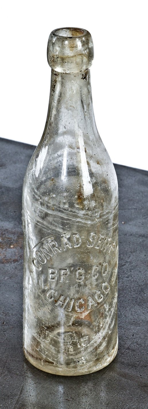 hard to find intact and completely intact c. 1870's colorless glass beer bottle fabricated for the conrad seipp brewing company in chicago, il.