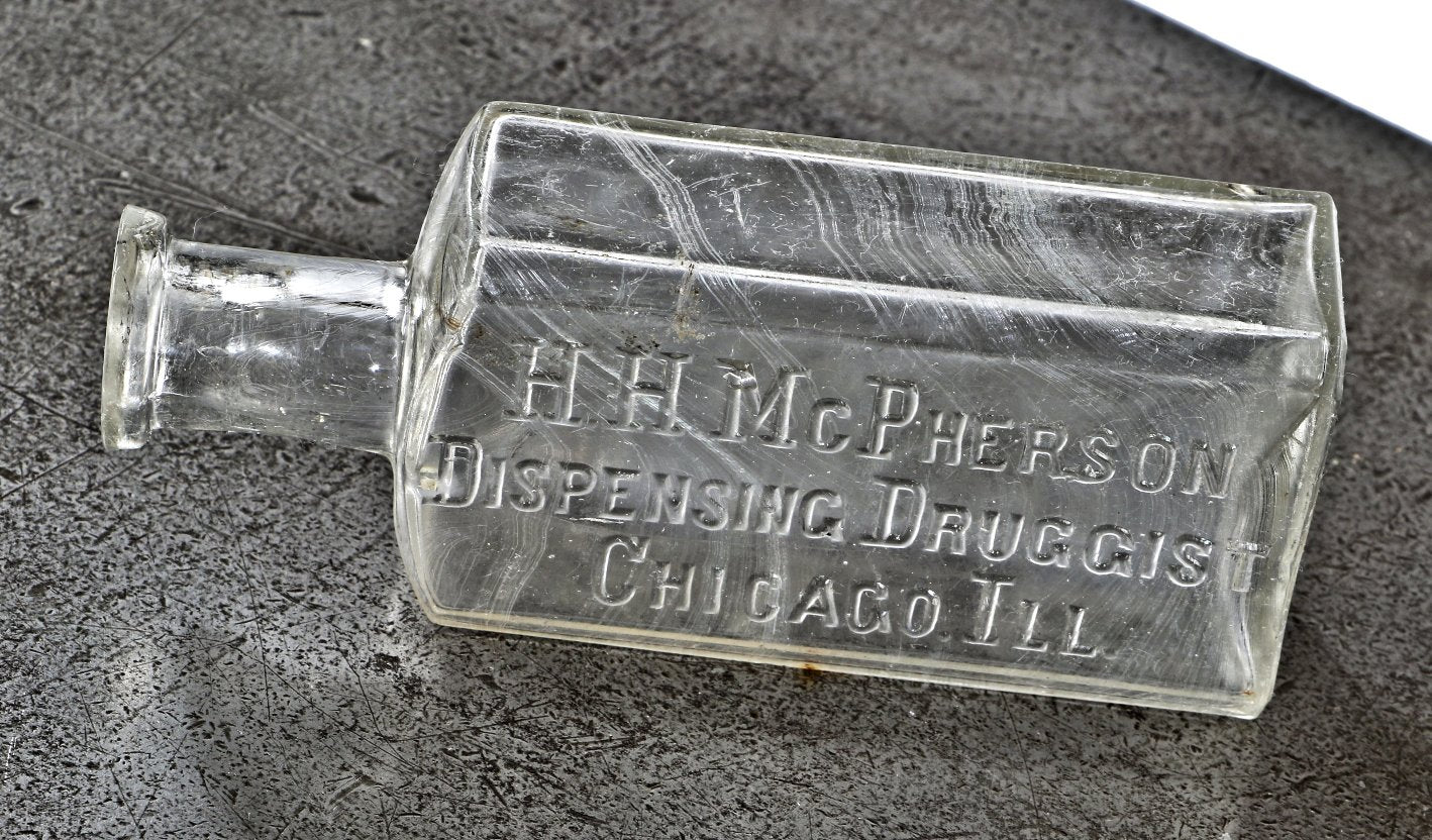 single intact antique c. 1890's american clear glass medicinal bottle fabricated for chicago druggist h.h. mcpherson and discovered in a chicago area landfill.
