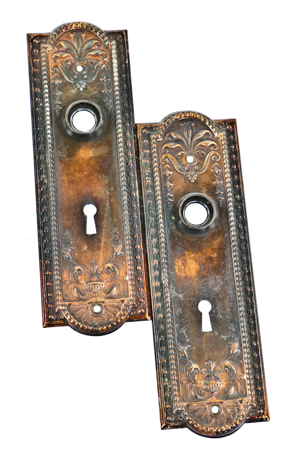 original early 20th century antique american "como" pattern interior residential oxidized copper-plated finish stamped steel doorknob backplates or escutcheons