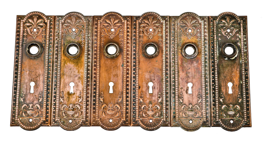 three set of original c. 1910 antique american interior residential "como" pattern ornamental metal doorknob escutcheons with nicely aged copper-plated finish