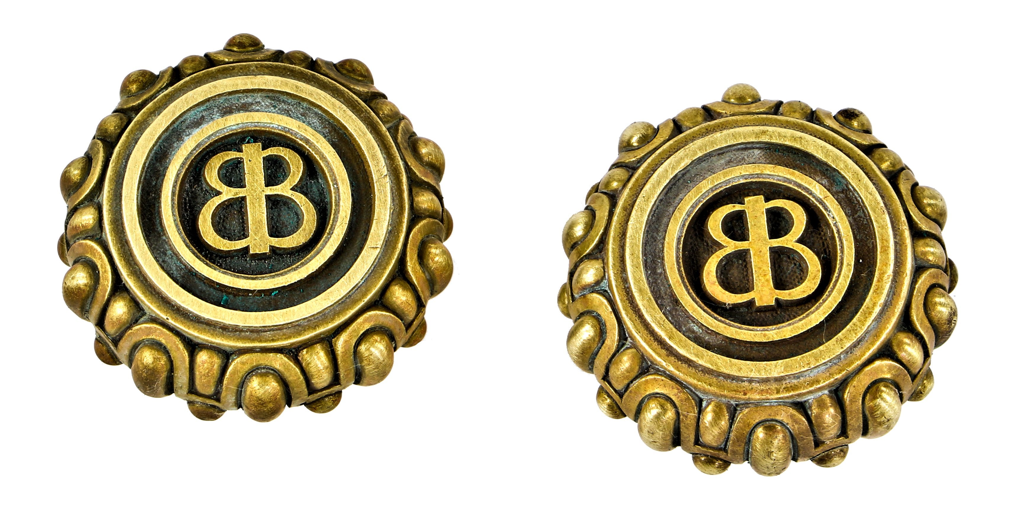 two matching "entry size" early 20th century heavy cast yellow brass baskin brother jewel store doorknobs with centrally located monogrammed design