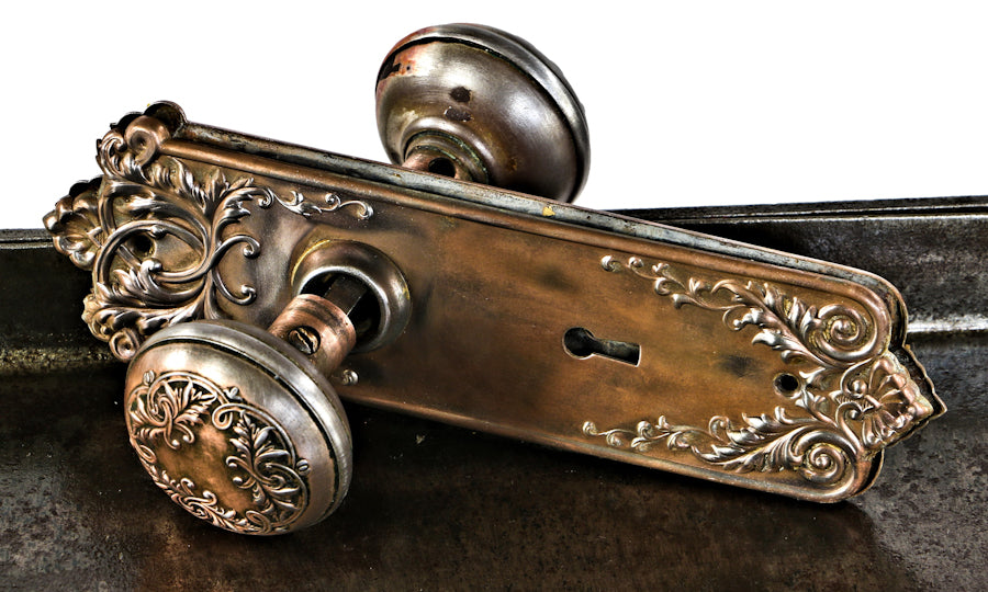 early 20th century antique american interior residential copper-plated stamped steel "loriane" pattern banded rim doorknobs with matching backplates or escutcheons