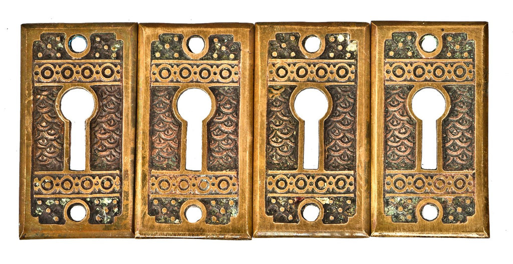 a group of original 1880's antique american ornamental cast brass interior residential "brocade" pattern oversized keyhole escutcheons