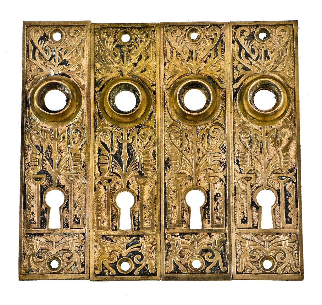 group of four matching all original c. 1880's cast brass interior church building eastlake style doorknob backplates with traces of original black enameled inlay