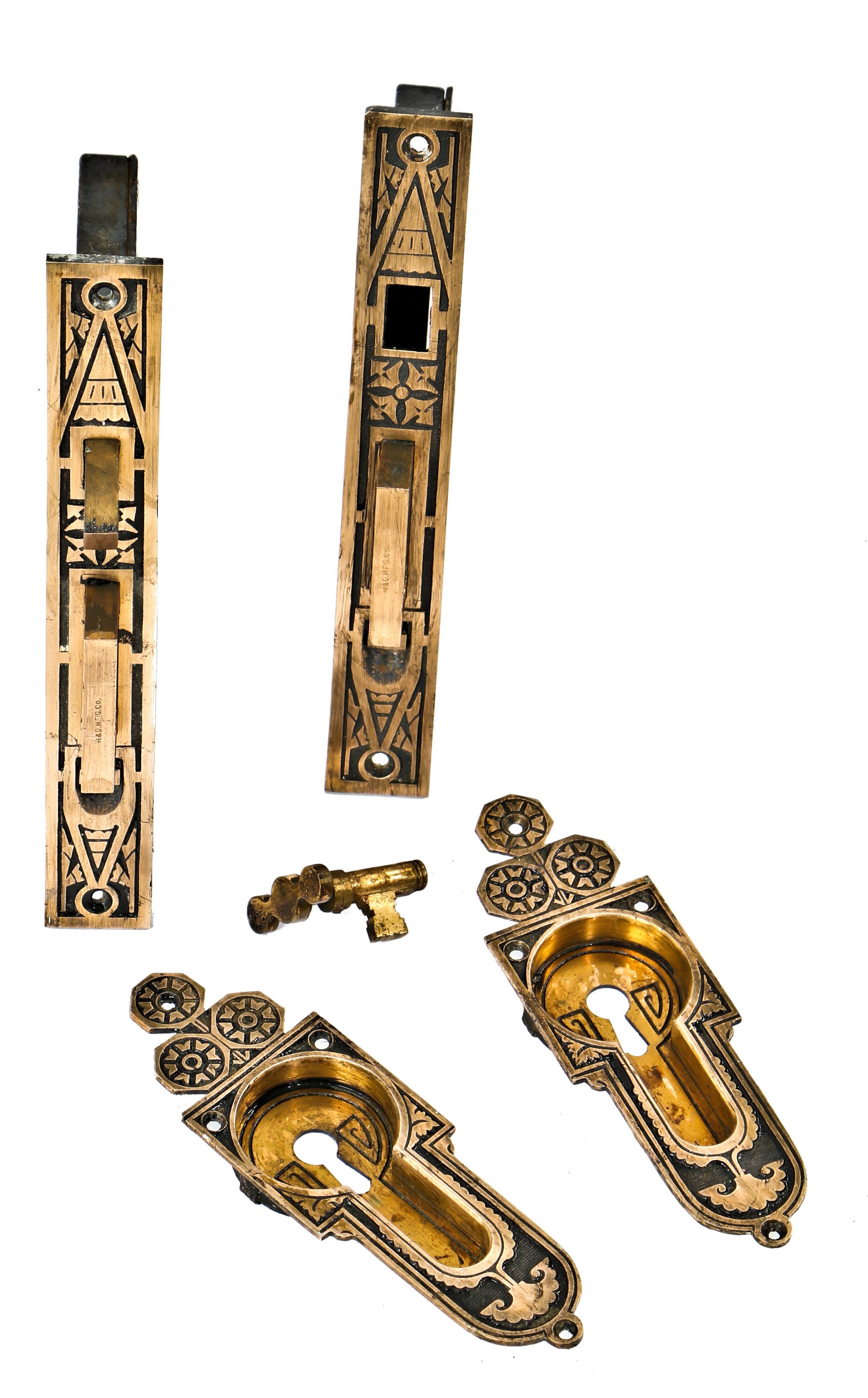 original late 1870's finely executed ornamental cast bronze chicago residential salvaged interior pocket door hardware with fully functional mortise locks and original key