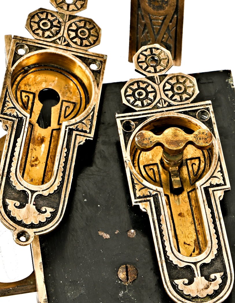 original late 1870's finely executed ornamental cast bronze chicago residential salvaged interior pocket door hardware with fully functional mortise locks and original key