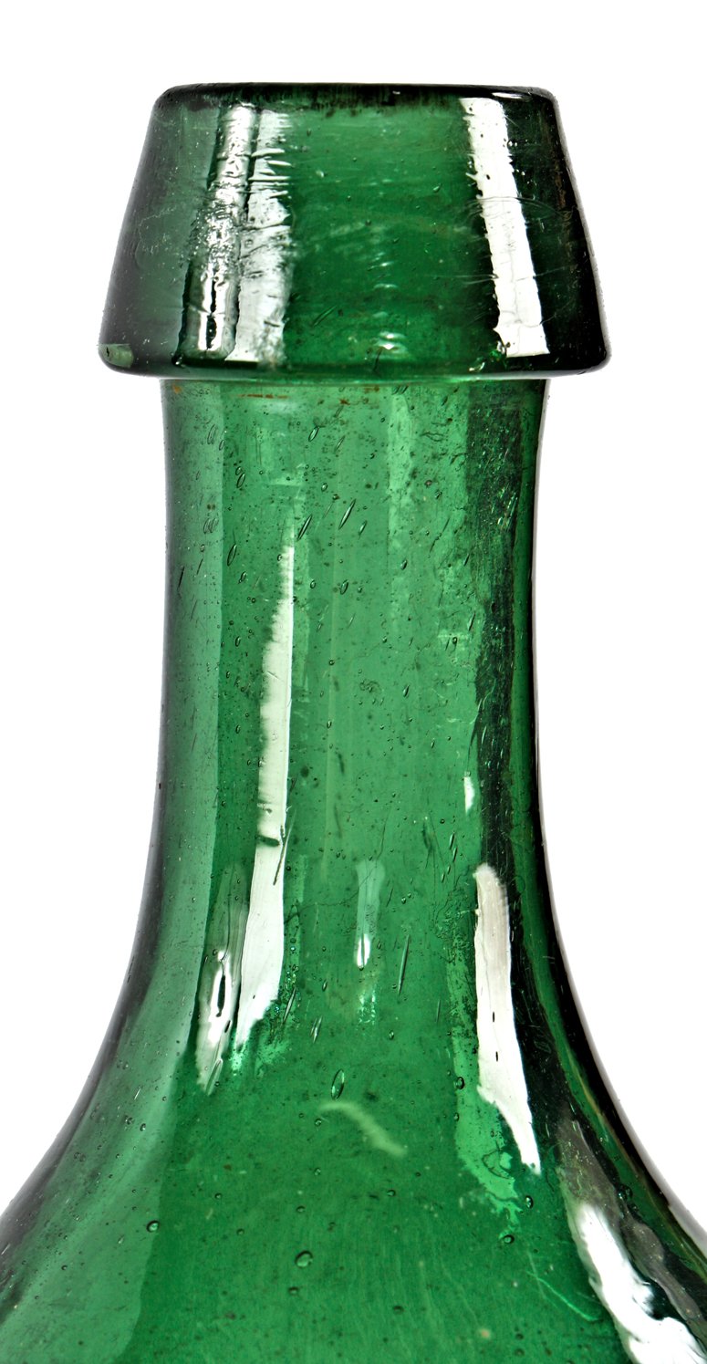 rare and all original antique mid-nineteenth century dark emerald green glass pontiled soda or mineral water bottle manufactured by the dyottville glassoworks in philadelphia.