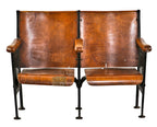 well-maintained all original c. 1920's antique american ornamental cast iron double-seat theater style chairs with stained birch wood seats and backrests