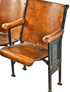 well-maintained all original c. 1920's antique american ornamental cast iron double-seat theater style chairs with stained birch wood seats and backrests