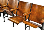 original and intact c. 1920's freestanding robust cast iron and varnished birch wood "theater" style drop-down four-seat chair section with flanking decorative seat ends