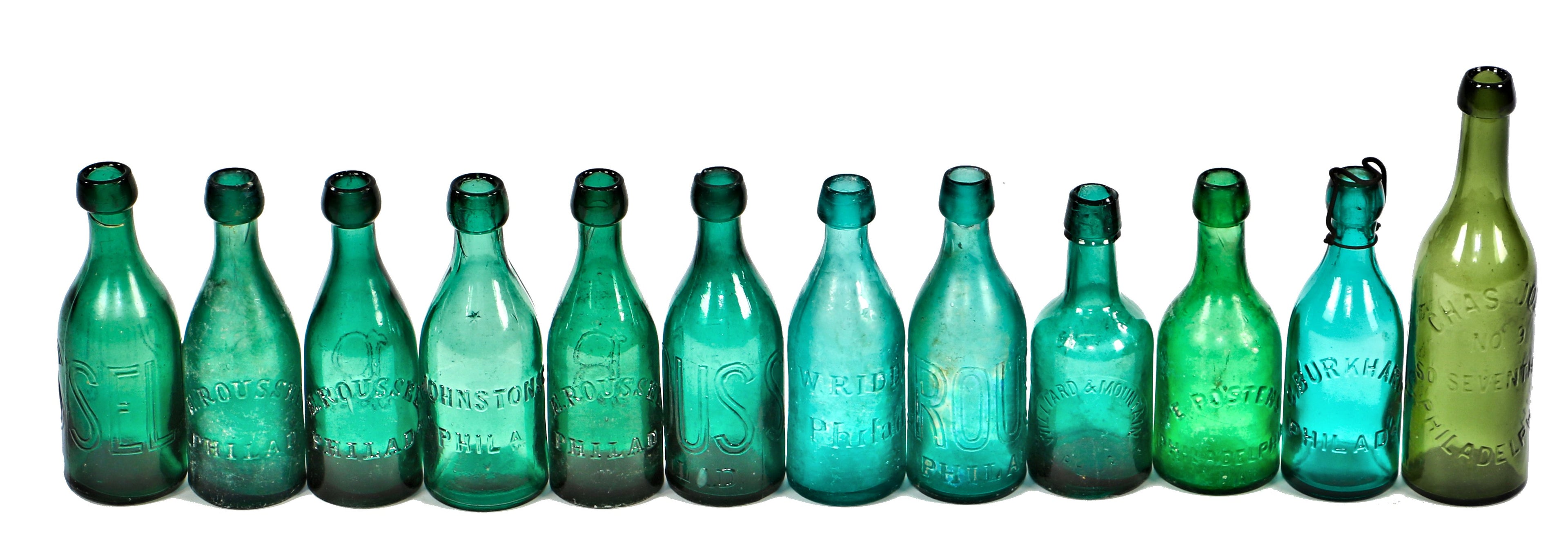large lot of original and intact antique mid-nineteenth century vibrantly colored green glass early soda bottles manufactured for various philadelphia bottlers