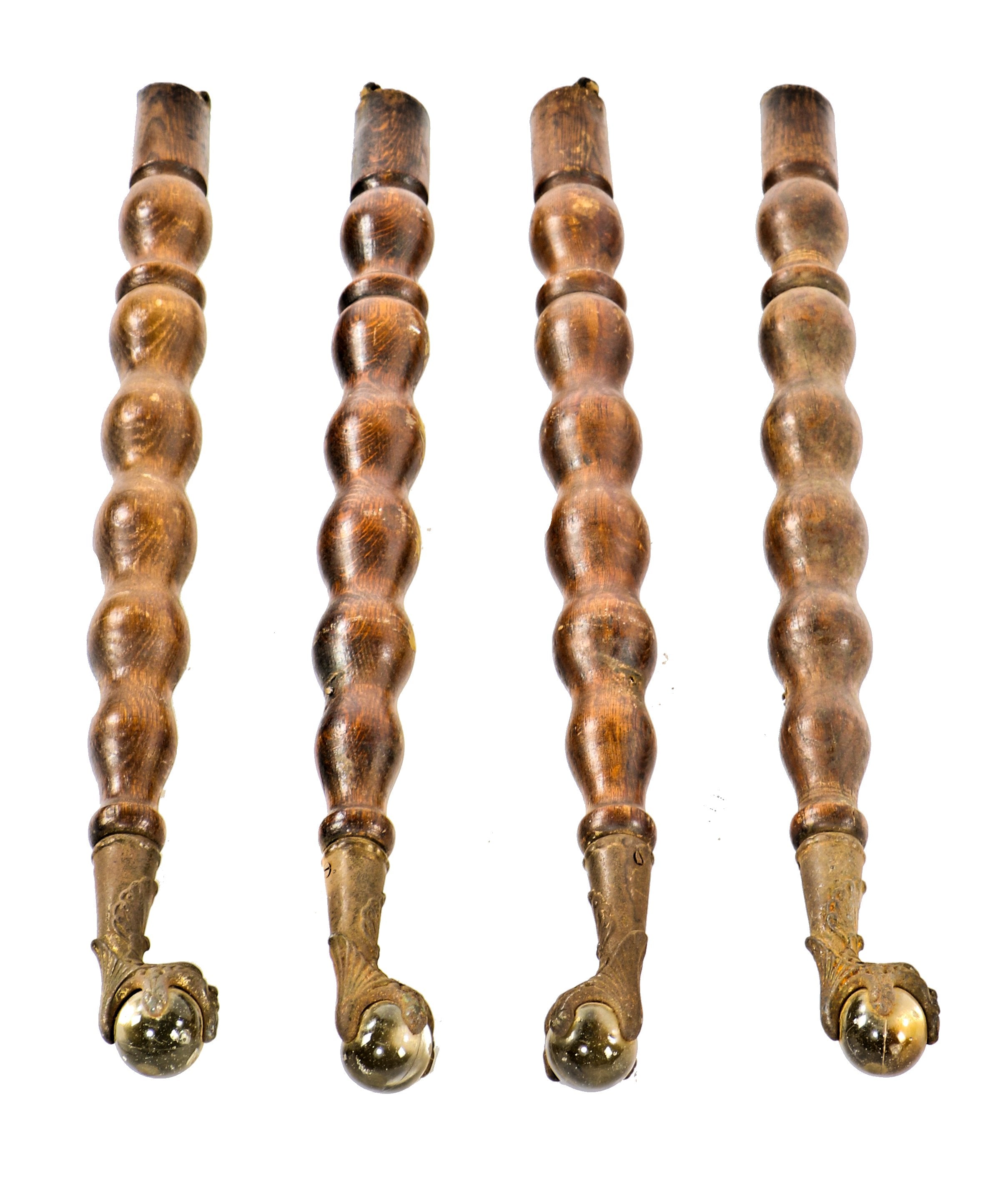 four matching original antique american darkly varnished turned solid oak wood furniture table legs with ornamental figural cast iron and glass "ball and claw" feet