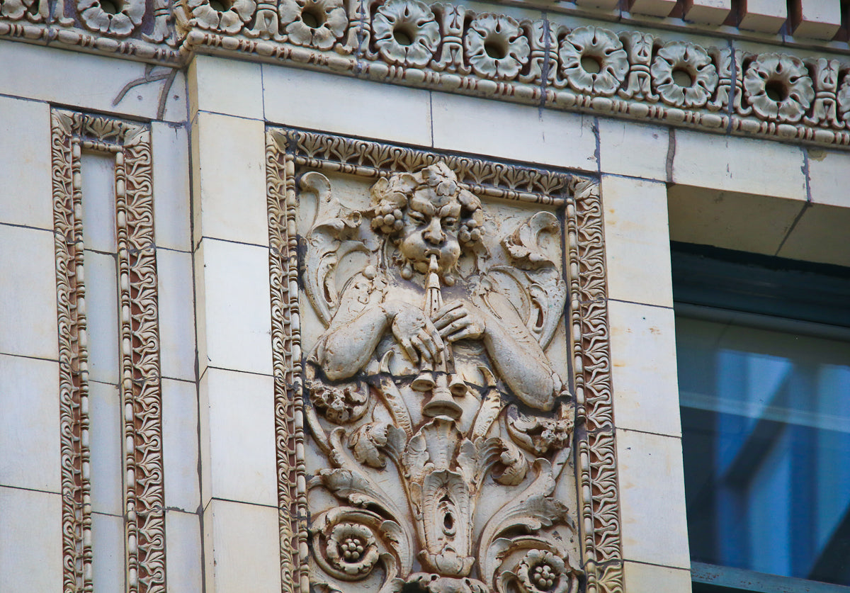 all original and intact "old ivory" glazed exterior historically important chicago theater terra cotta panels with centrally located opening for light bulb