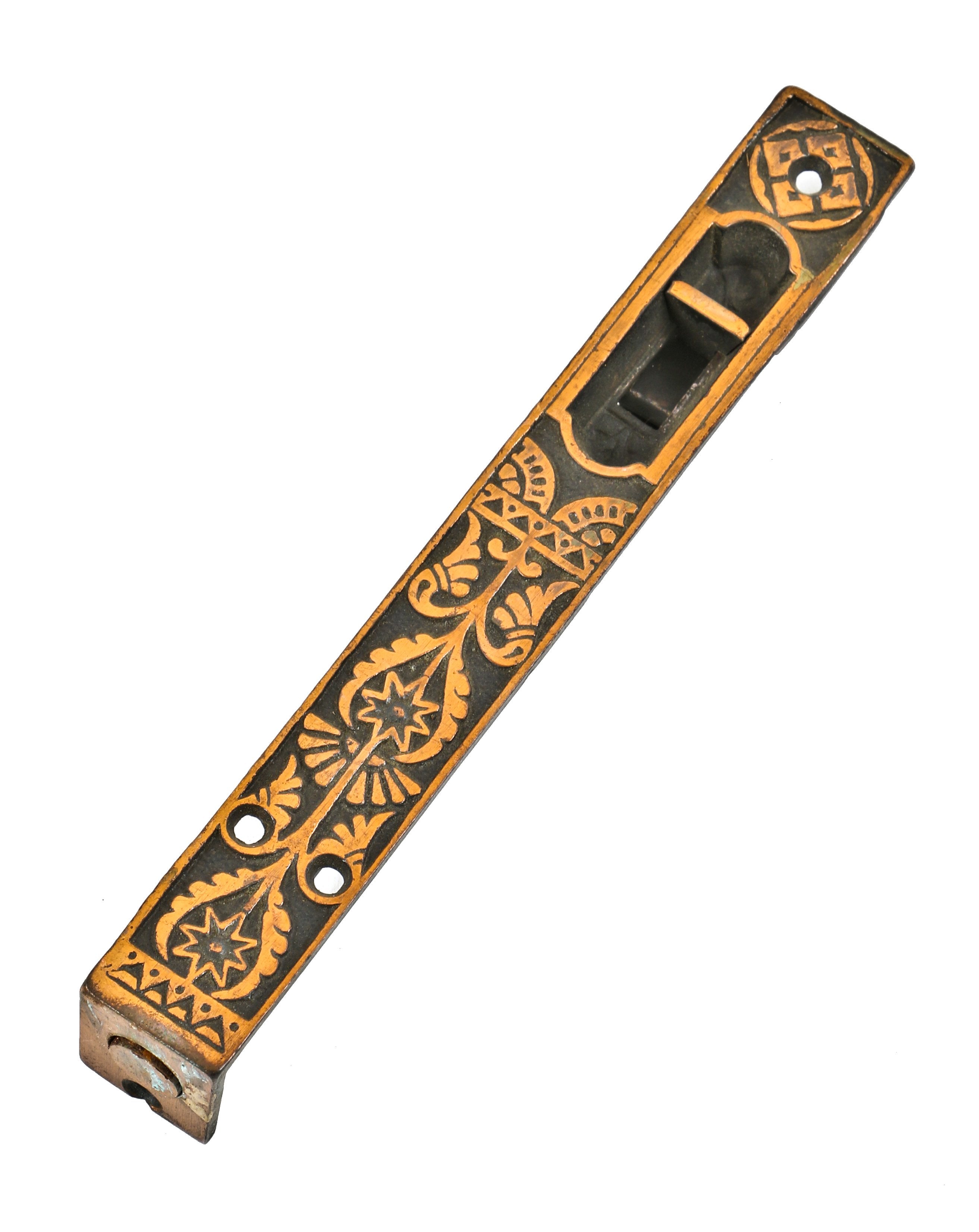 all original "new old stock" copper-plated cast iron residential entrance door flush-mount ornamental retractable door bolt with light surface wear evident