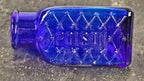 mint condition all original early twentieth century machine made deep cobalt blue 3-sided "poison" jar fabricated for the united drug company, of boston and st. louis