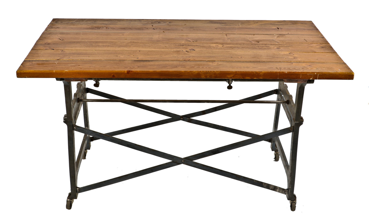 fully functional and intact antique american industrial repurposed oversized mobile shop table supported by "medart" cast iron workbench legs or bases