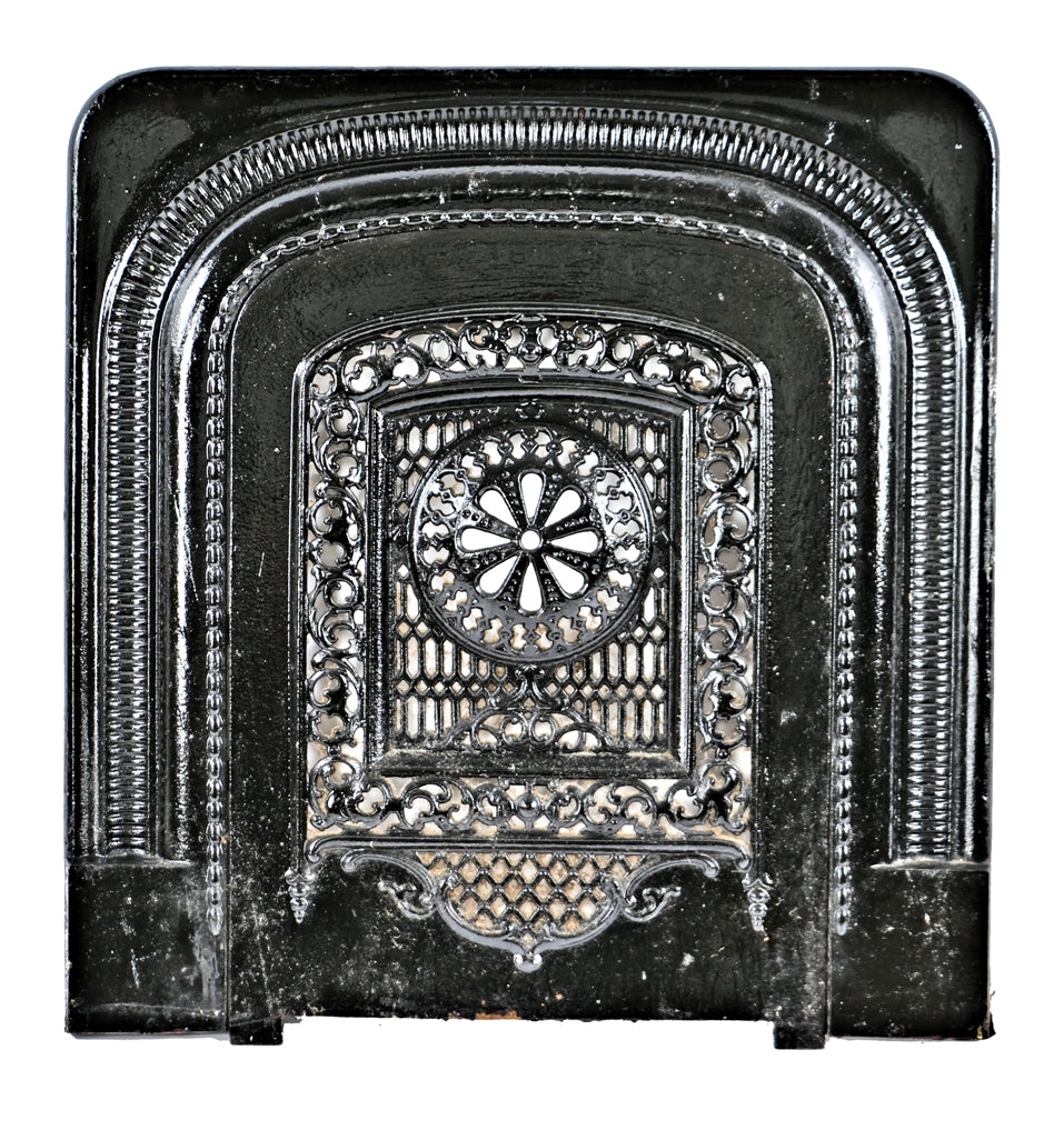original c. 1874 interior residential ornamental cast iron two-piece fireplace summer cover and surround with mostly uniform black enameled finish