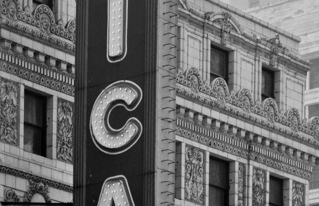 all original and intact "old ivory" glazed exterior historically important chicago theater terra cotta panels with centrally located opening for light bulb