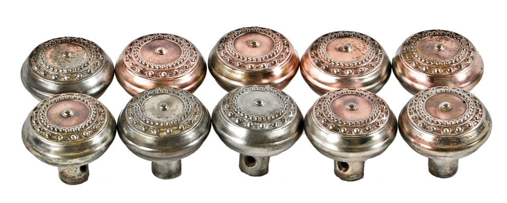 group of eight matching interior residential salvaged chicago "como" pattern copper-plated pressed steel banded rim passage door handles with bead motif