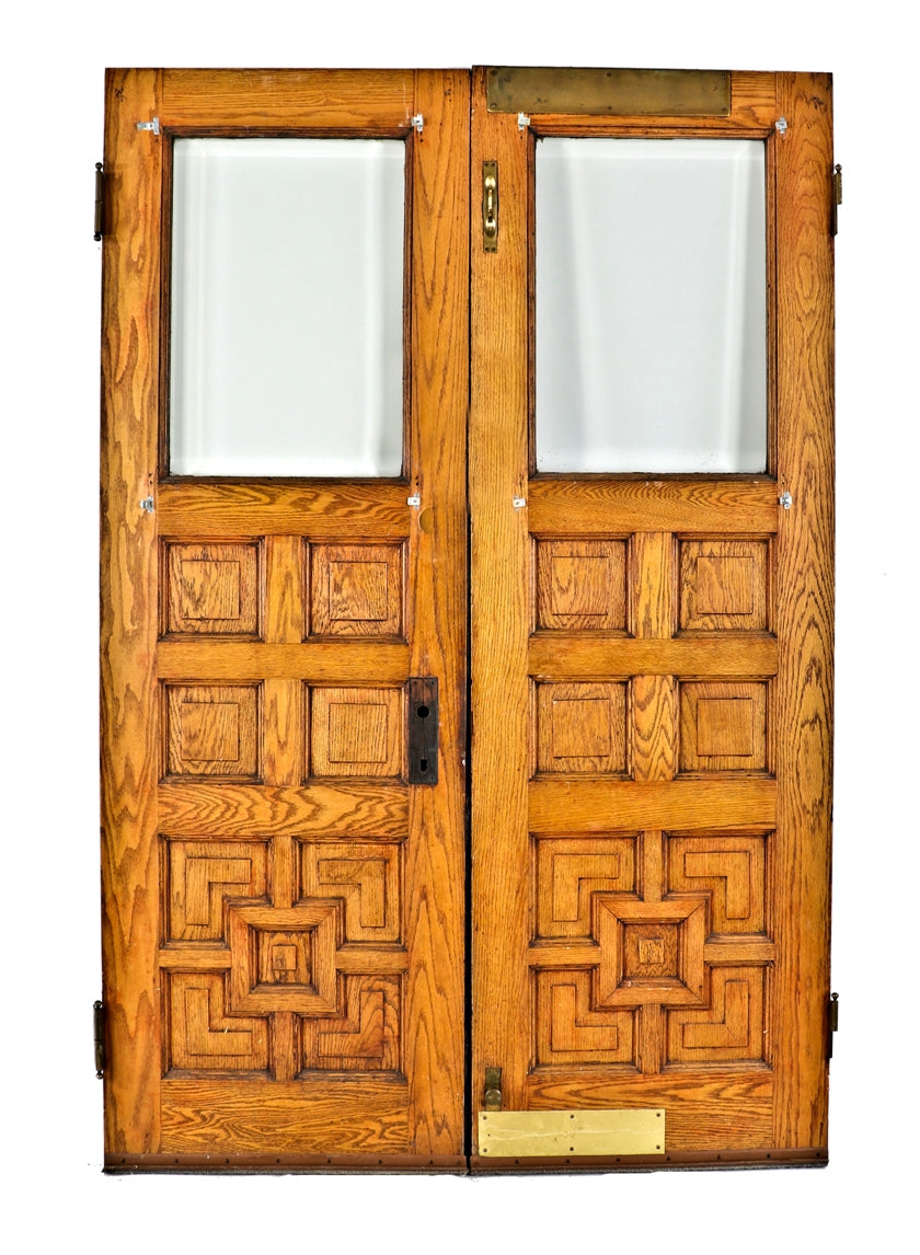 matching set of well-maintained salvaged chicago 1880's salvaged oak wood paneled entrance doors with original beveled edge clear plate glass