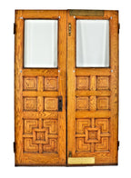 matching set of well-maintained salvaged chicago 1880's salvaged oak wood paneled entrance doors with original beveled edge clear plate glass