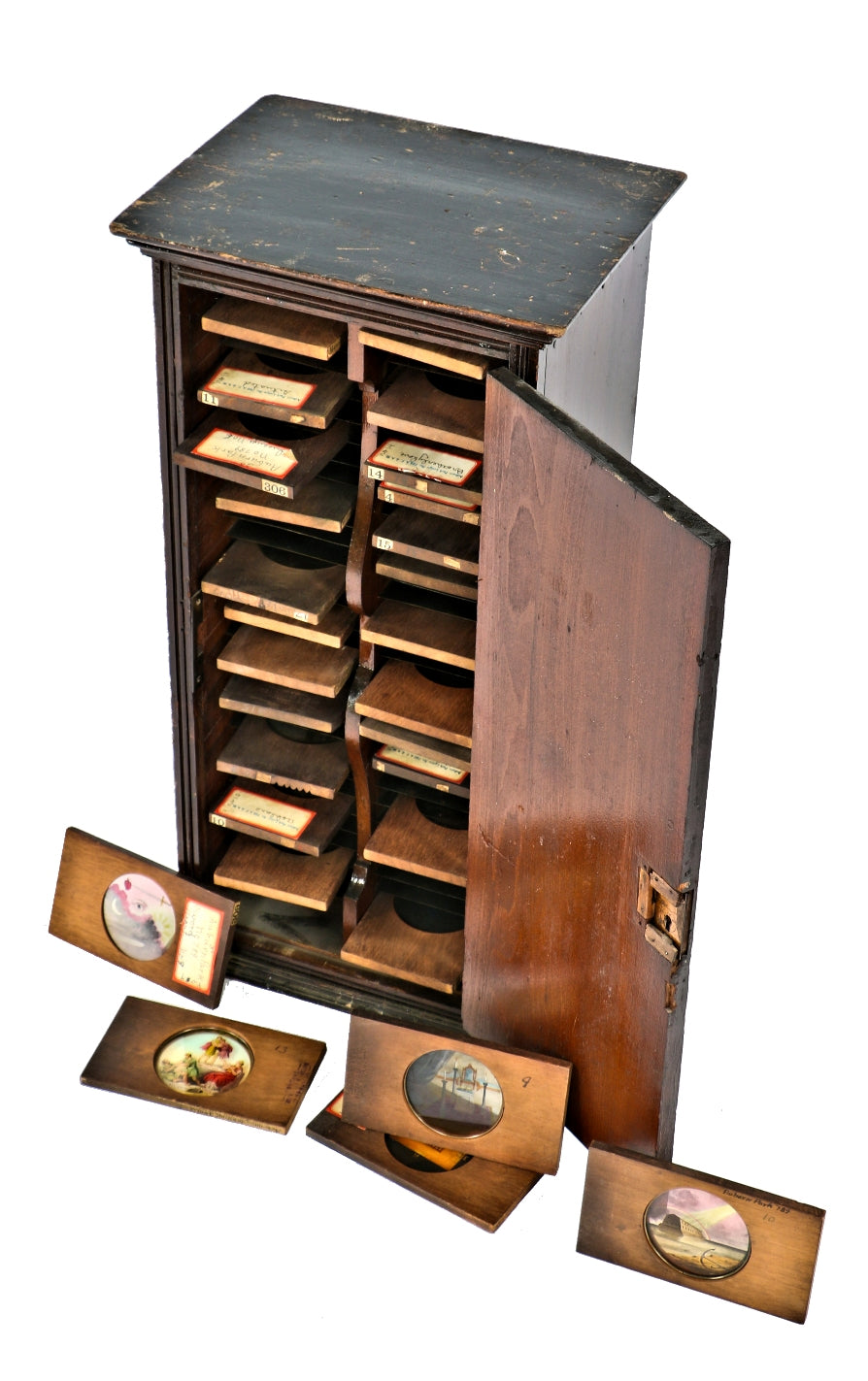 assortment of early 20th century masonic or oddfellow "magic lantern" glass slides with original compartmentalized wood storage cabinet
