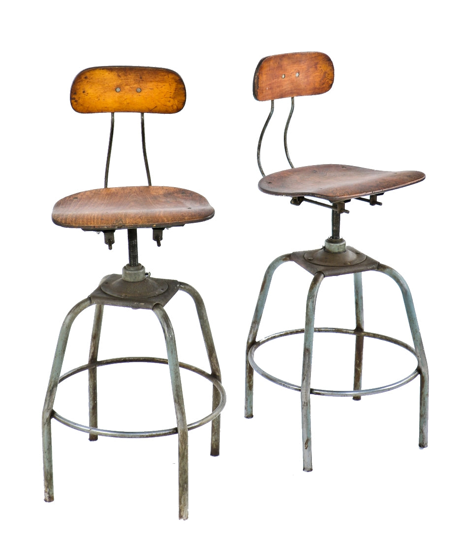 pair of original matching fully adjustable c. 1940's tubular steel plating factory stools with maple wood saddle seats and and slightly contoured backrests